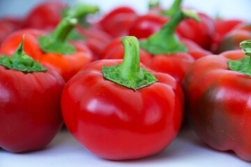Red bell pepper on the counter in the supermarket. Large amount of red pepper in a heap