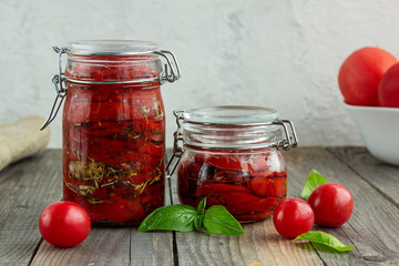 dried tomatoes in a jar in spiced oil.