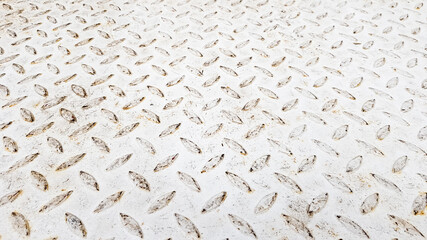 White steel sheet with embossed diamond pattern, used for floors and industrial building. White vintage steel plate useful as background