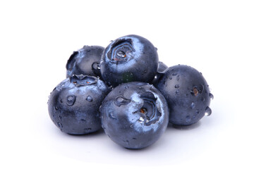 Pile of Juicy Blueberries fruits with water droplets isolated on white background.