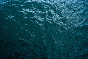 Sea waves, dark water of a beautiful color, top view. Horizontal photography.