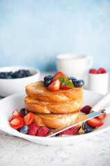 Traditional fried French toast with honey and fresh berries, breakfast
