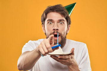 birthday boy in a cap with cake fun yellow background party