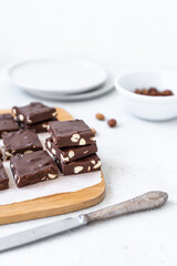 Chocolate fudge with nuts on a gray background. Homemade dark chocolate brownies.