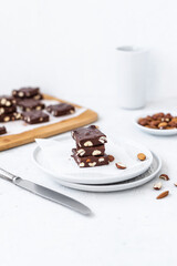 Chocolate fudge with nuts on a gray background. Homemade dark chocolate brownies.