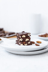 Chocolate fudge with nuts on a gray background. Homemade dark chocolate brownies.