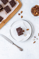 Chocolate fudge with nuts on a gray background. Homemade dark chocolate brownies.