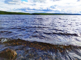 Large stones rocks on the lake shore at sunset