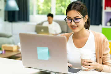 Quarantine couple working from home with laptop