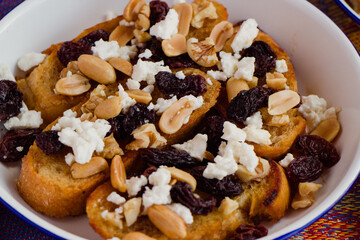 Capirotada close-up. Is a traditional dish from Michoacán, Mexico that includes bread, peanuts, sugar cane locally known as piloncillo, cheese, raisins and nuts