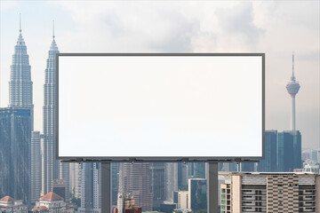 Blank white road billboard with KL cityscape background at day time. Street advertising poster, mock up, 3D rendering. Front view. The concept of marketing communication to promote or sell idea.