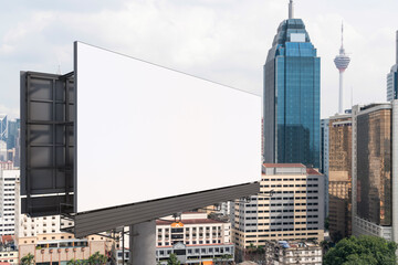 Blank white road billboard with KL cityscape background at day time. Street advertising poster, mock up, 3D rendering. Side view. The concept of marketing communication to promote or sell idea.