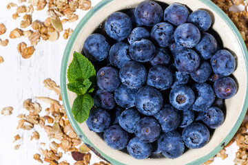 fresh juicy blueberries and homemade granola, closeup