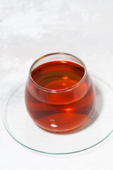 glass cup of tea on a white background, vertical
