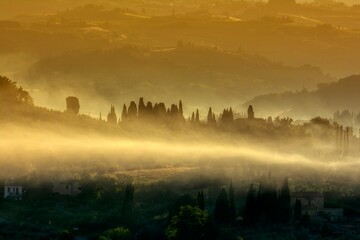 Beautiful sunset with fog at San Gimignano, Italy.