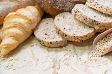 Fresh homemade bread with cereal and grain on paper. Different bakery products on brown paper background. food meal concept
