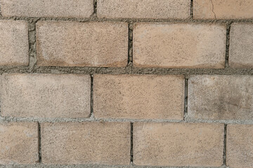 Wall of big brick white texture background. Texture of a brown stone wall construction.