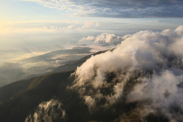 Cloudy mountains and misty valley in the morning.