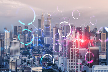 Fototapeta na wymiar Hologram of abstract technology glowing icons, panoramic cityscape of Kuala Lumpur at sunset, Malaysia, Asia. The concept of worlds technological changes. Double exposure.