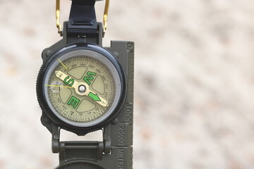 classic navigation compass against background of sandy beach as symbol of tourism with compass,...