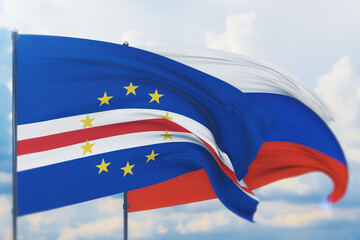 Waving Russian flag and flag of Cape Verde. Closeup view, 3D illustration.