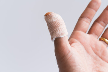 Thumb finger injury  accident.The medicine bandage on injury finger on white background.