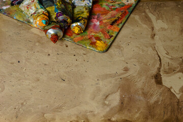 Tubes of multicolor oil paint on canvas close-up