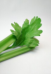 
celery stick and leaf on isolated white background