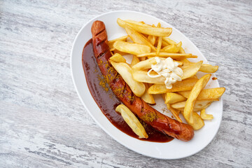 Currywurst, popular fast food in Germany consisting of sausage with curry ketchup, served with...