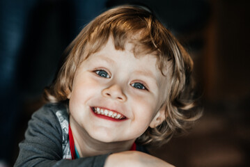 attractive boy of three years old smiling with teeth with looking at the camera, joy. happy childhood of child and son