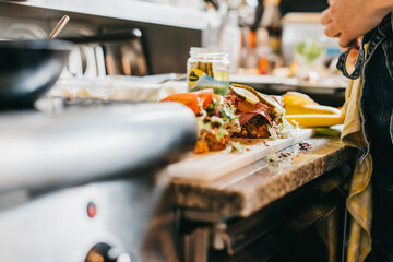 Close Up Of A Pastrami Sandwich Being Made In The Kitchen