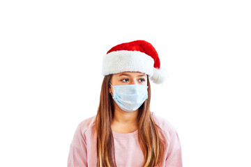 Fototapeta na wymiar Girl in red Santa Claus Christmas hat and medical mask looking away isolated on white background. Protection against viruses, infection prevention. Christmas time