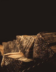 Chopped firewood on a dark background