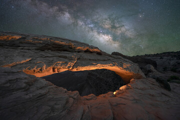 Fototapeta na wymiar Mesa Arch lit at night under the Milky Way Galaxy
