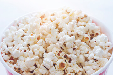 Popcorn in striped box on white background