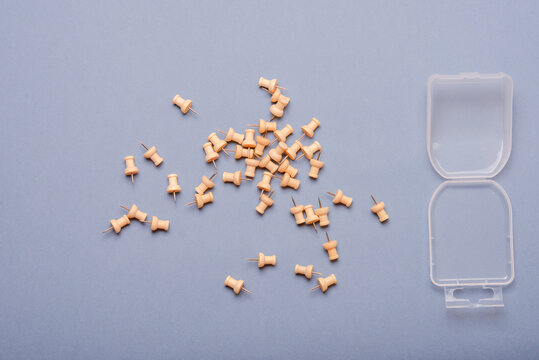 Scattered thumbtacks and box