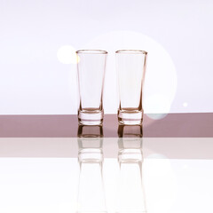 daylight. glass on a burgundy background. Reflection in the shadow. Copy space. text.