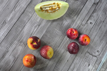 Summer fruits, melon, red plums and nectarine.