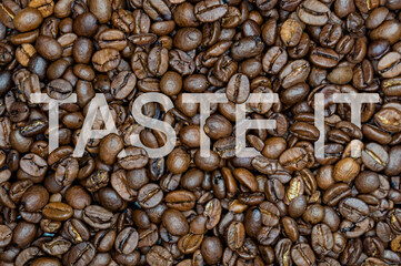 inscription coffee on the background of coffee beans