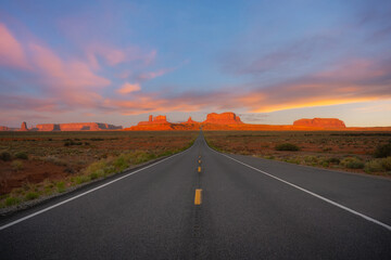 Long road leading towards Monument Valley in Utah