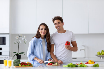 Happy couple is preparing healthy food on light kitchen, enjoy morning.