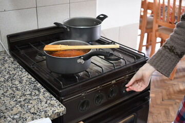 young woman cooking salsa on a Sunday