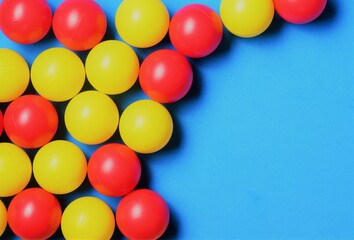 Group of red and yellow balls, on blue background and space for text
