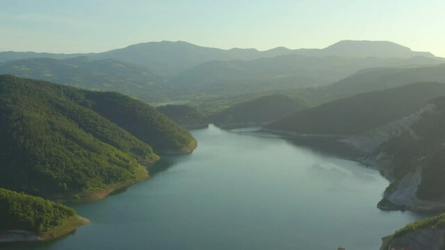 Aerial shot of Serbia. Drone video hydro power plant standing in the mountains where you can see forests, water, lake, dam, beautiful landscape.