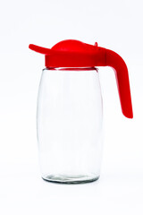 daylight. on a white background. Glass decanter with a bright red lid. The concept of replacing...