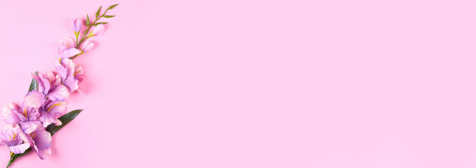 Fototapeta na wymiar Decorative flowers on pink background composition. Flat lay photo.