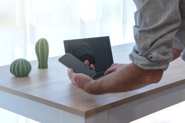 Man with vitiligo Skin Condition on his arms, working with a phone. Concept work from home.