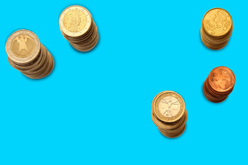 metal coins of european union euro piles on blue background, business concept, copy space