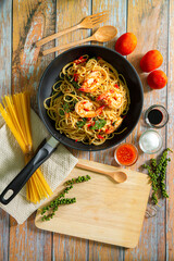 Stir-fried Spicy macaroni Seafood Thai Style on black Dish. This menu has a spicy flavor. Space for text. Overhead. Dark rustic table