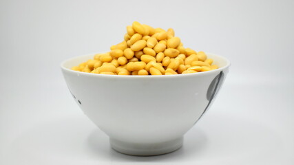 Soybeans after soaking for 24 hours in a bowl on a цршеуbackground